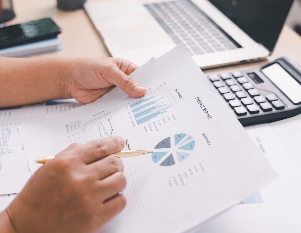 Financial adviser reviewing charts and financial reports for retirement and inheritance planning.