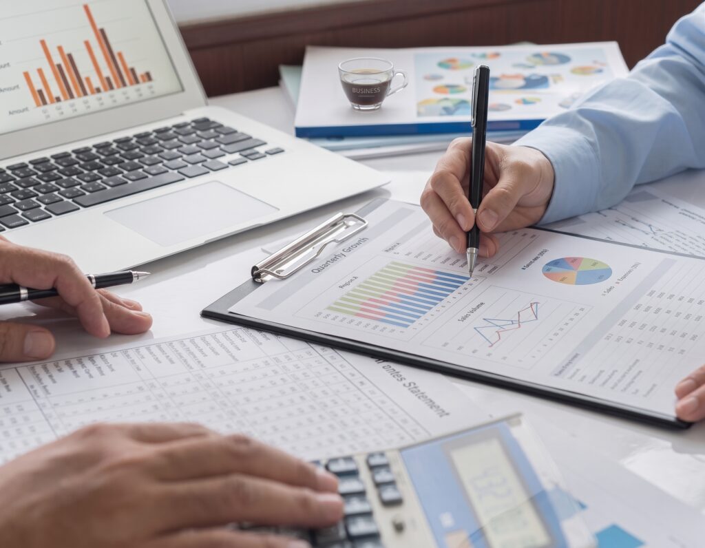 Business owners reviewing financial reports as part of retirement planning